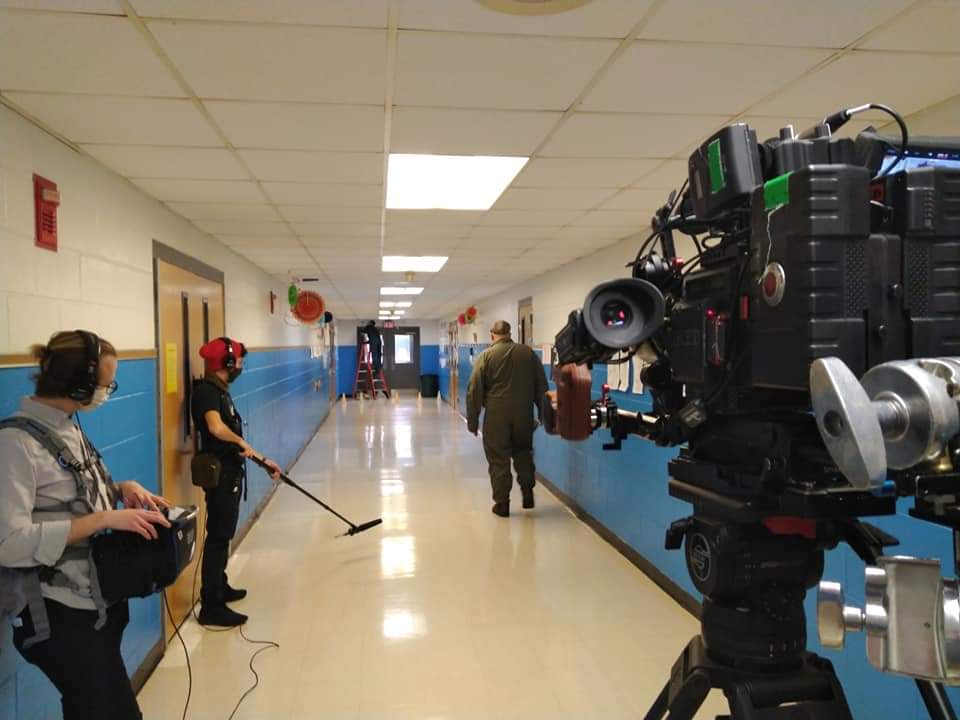 a man wearing a mask and holding a remote