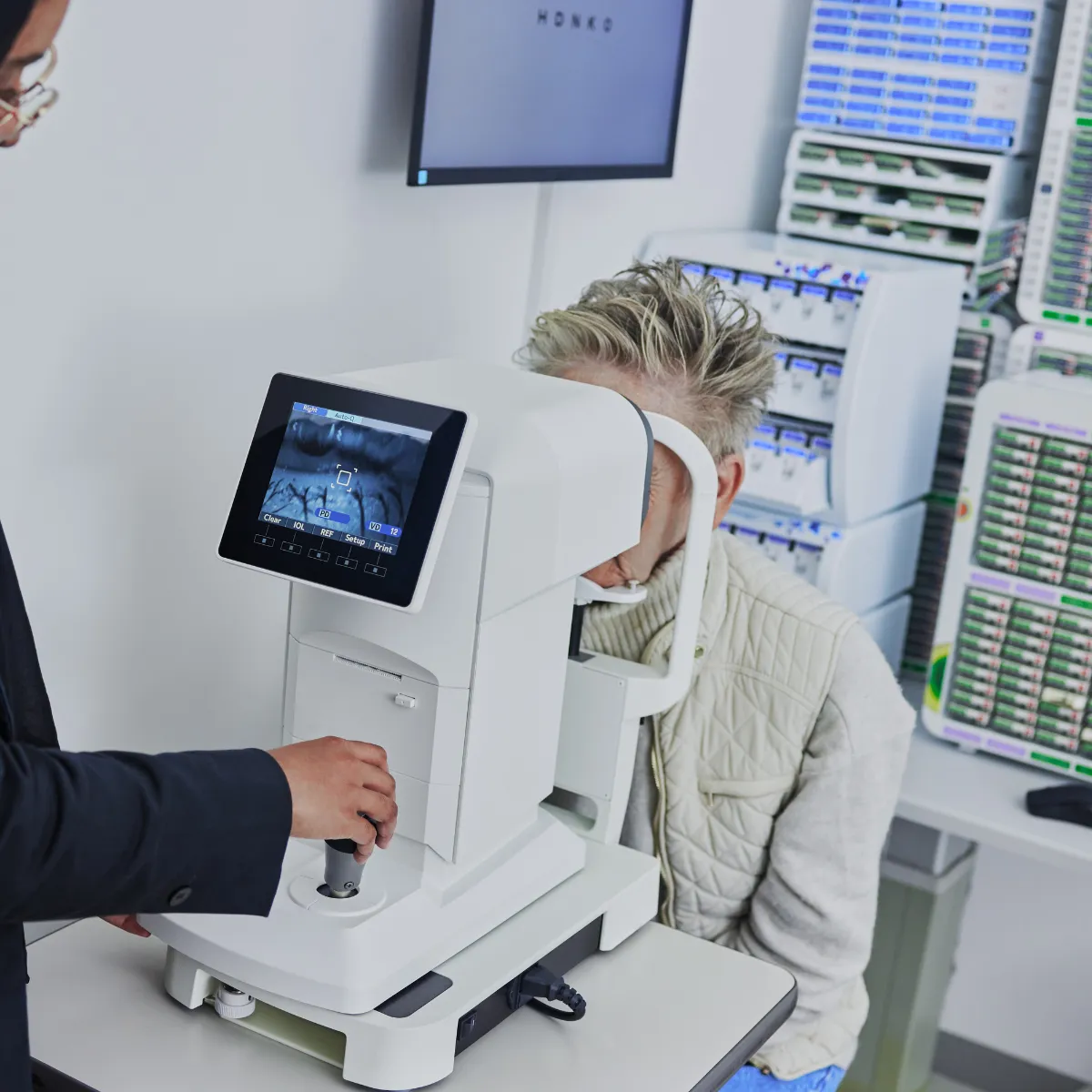 Patient using an automated refraction machine for prescription glasses