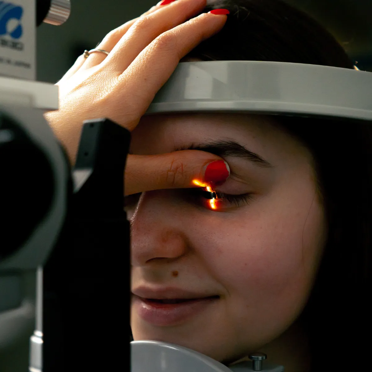 Woman receiving an eye exam with a retinal light check