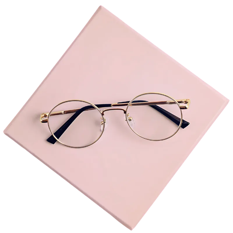 Gold round eyeglasses placed on a soft pink square background