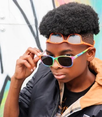 Optometrist performing an eye exam for a seated patient using clinical equipment