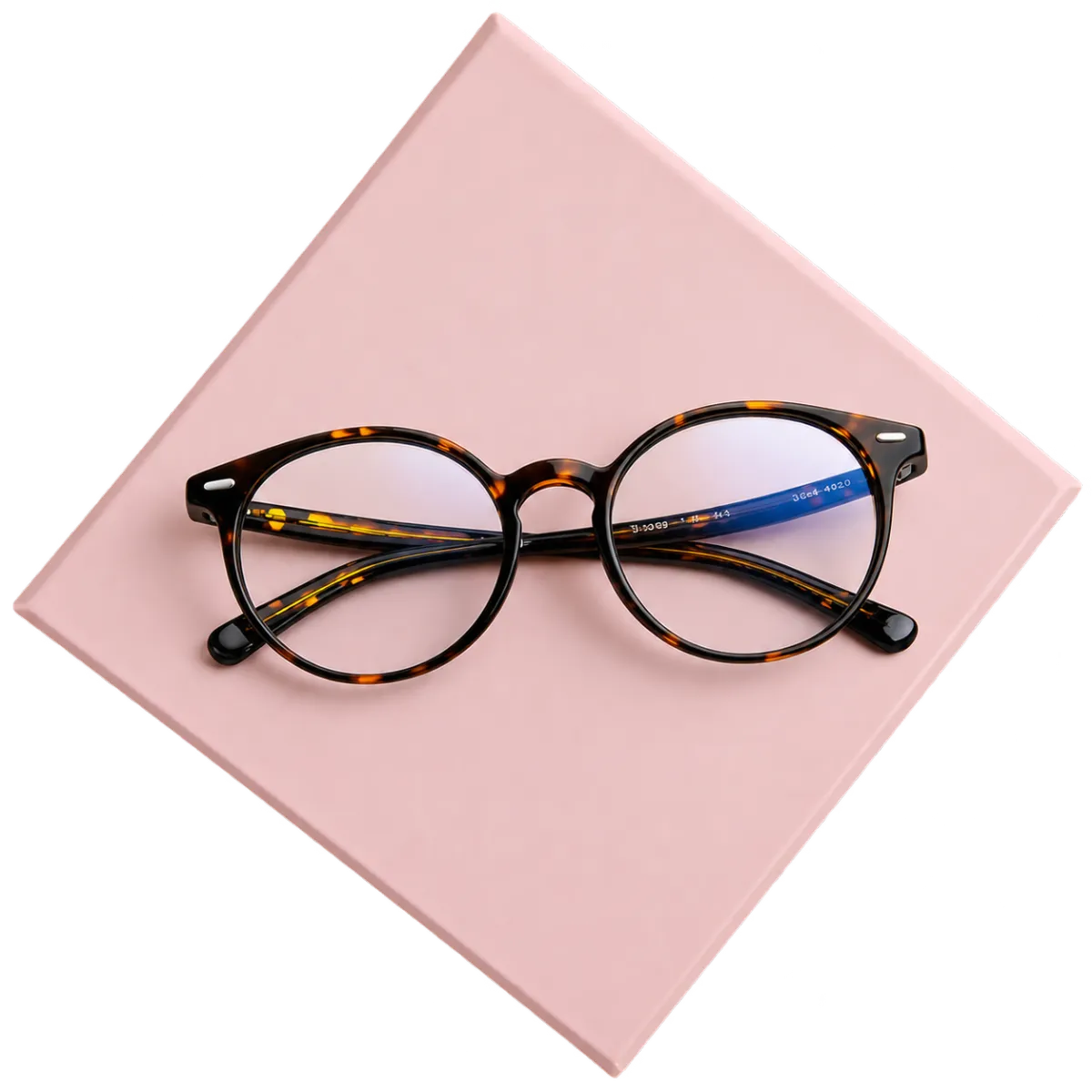 Gold round eyeglasses placed on a soft pink square background