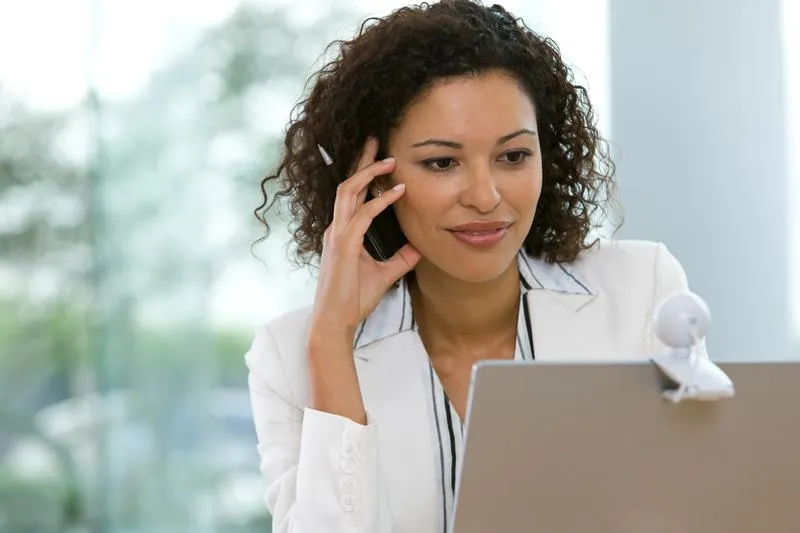 woman smiling at computer