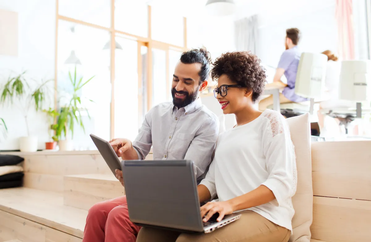 woman and man sitting in front of monitor