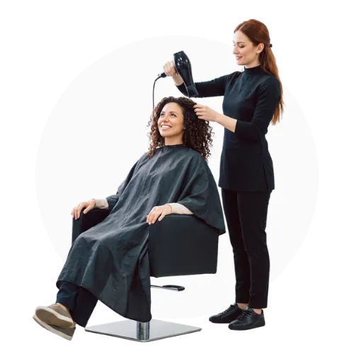 Stylist blow drying customer's hair