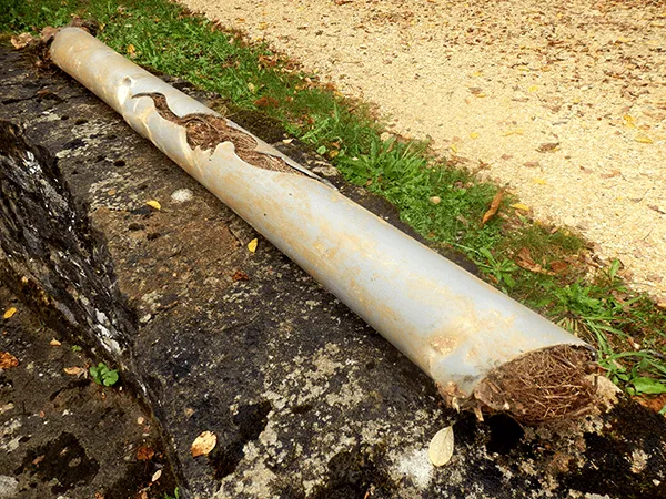 Plumber repairing a leaking pipe under a kitchen sink in Western Sydney