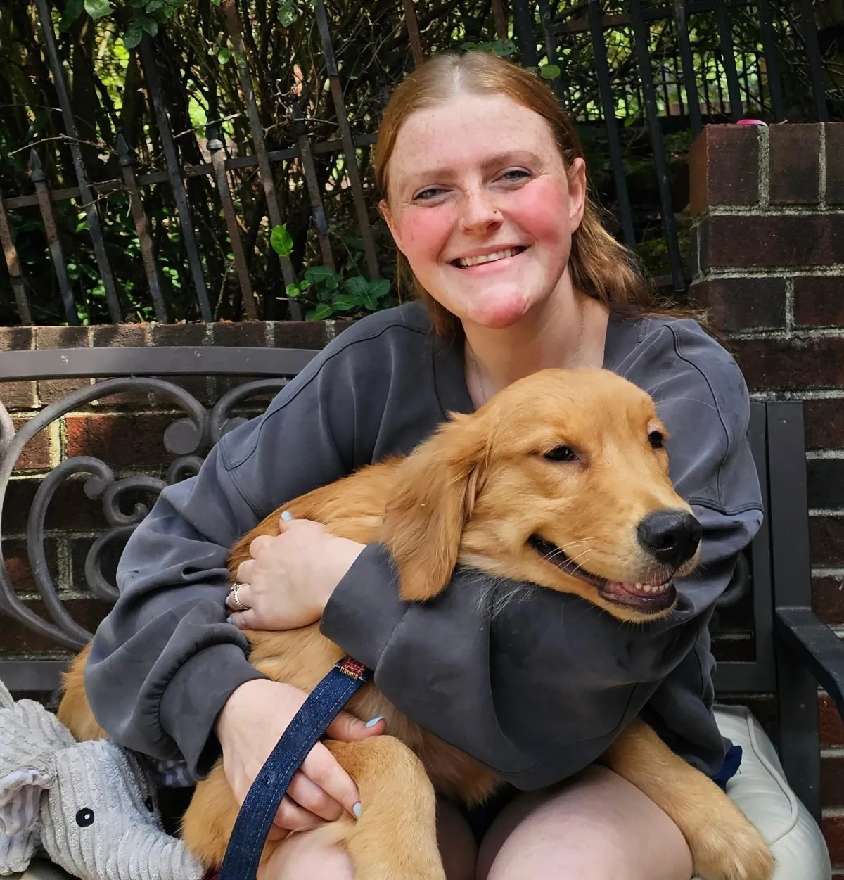 Candice Vincent, a veterinary technician with a stethoscope, smiling in a professional setting, representing compassionate veterinary care and expertise in emergency and critical care.