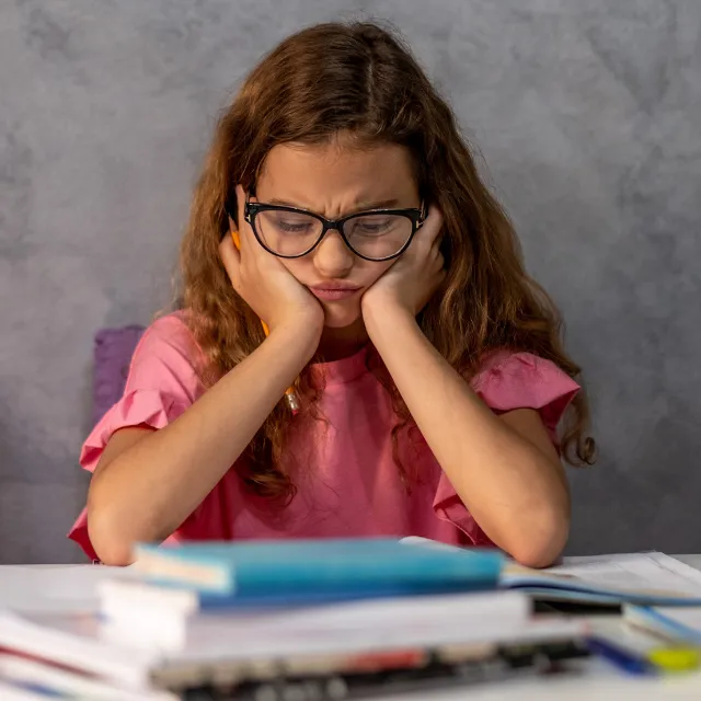 Girl looking worried as she struggles to focus on her work
