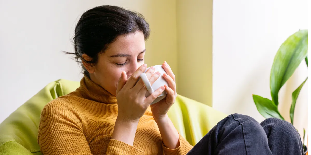 Parent taking a quiet moment for self-care, representing wellbeing, rest and emotional resilience