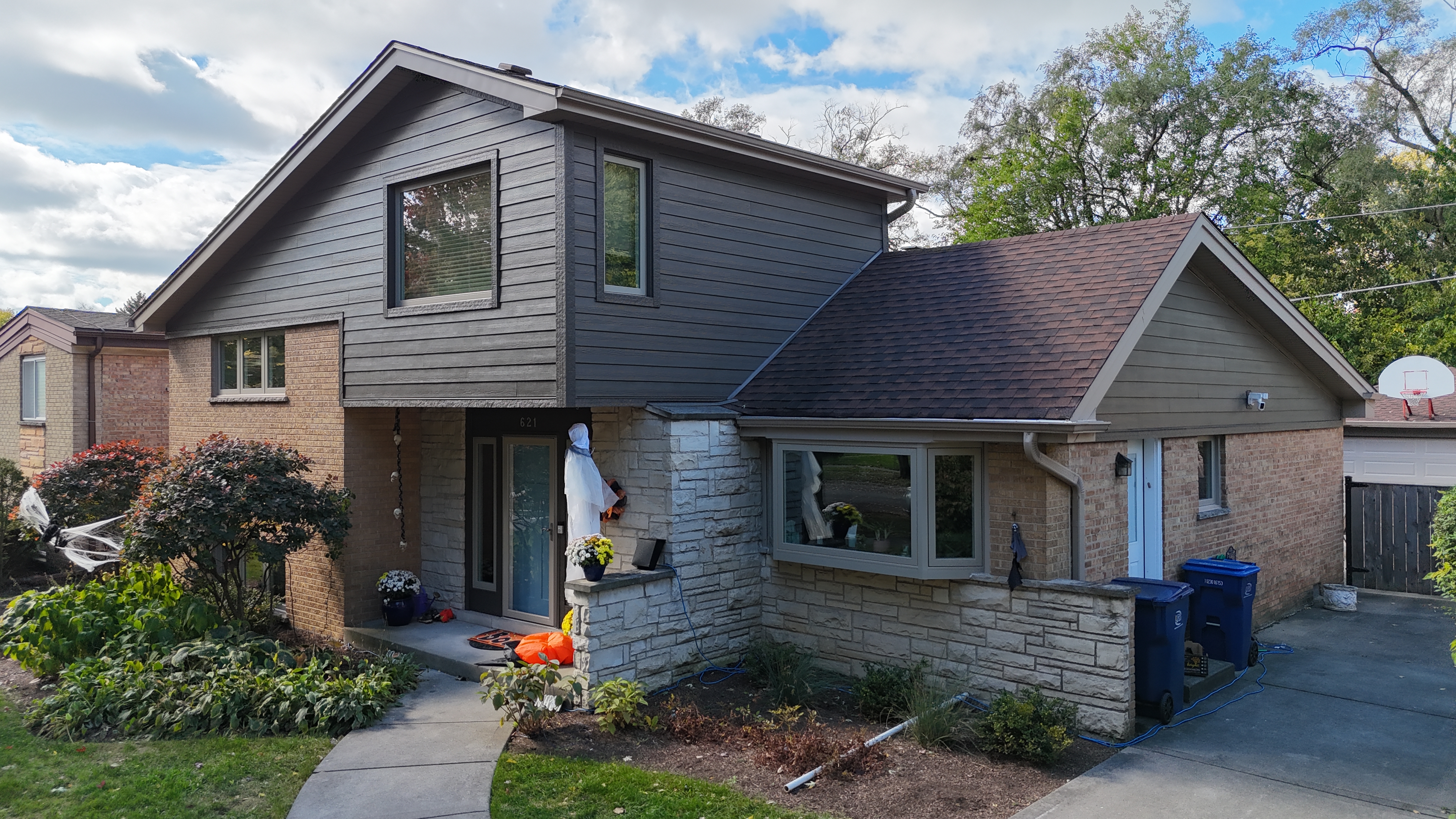 Rich Espresso James Hardie siding and trim paired with new windows from Midway Alliance installed on a home in Wilmette, IL by Northwind Exteriors.