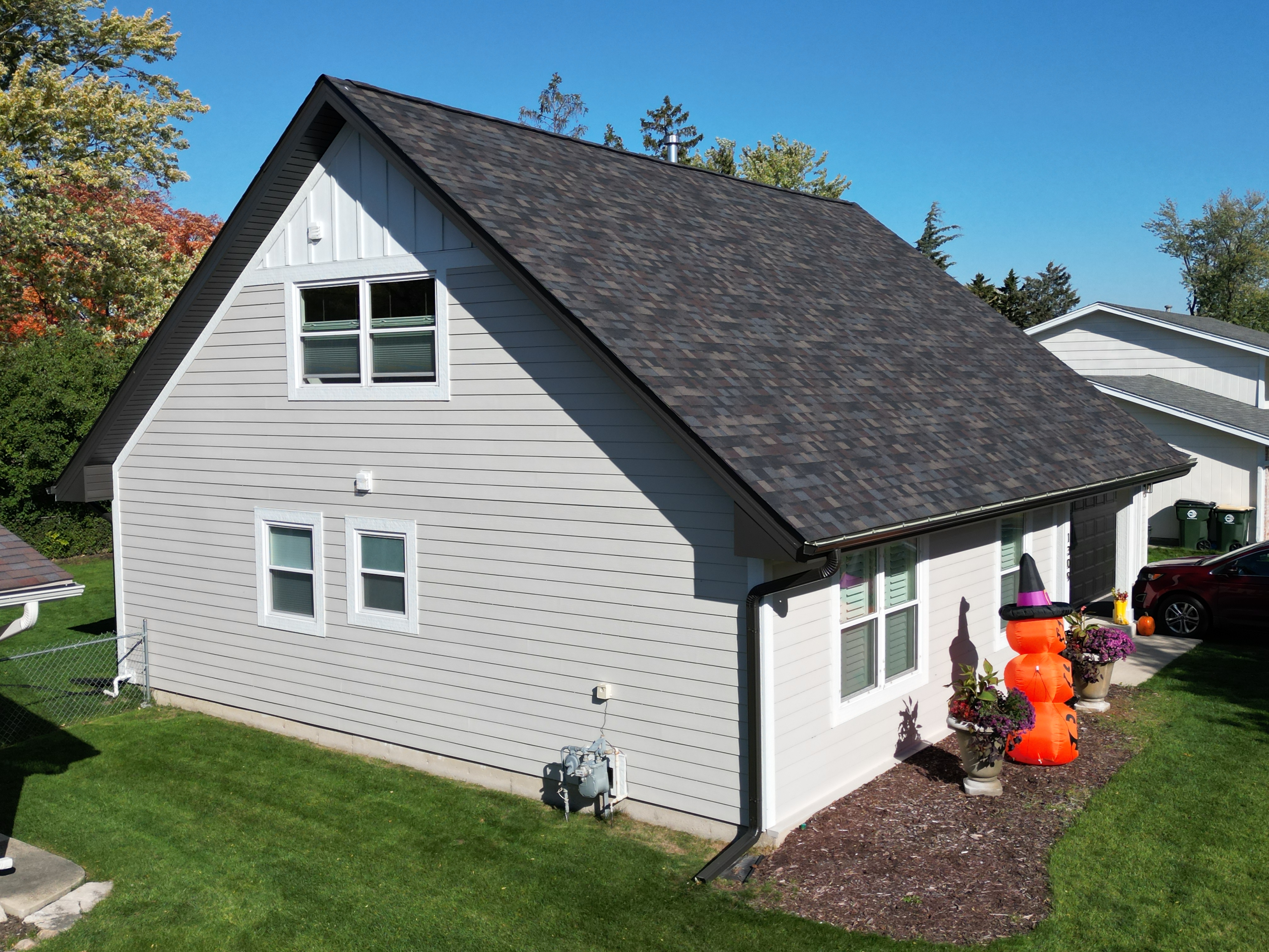 James Hardie siding project in Elk Grove, IL by Northwind Exteriors featuring Cobblestone siding with Arctic White trim for a timeless and elegant home exterior