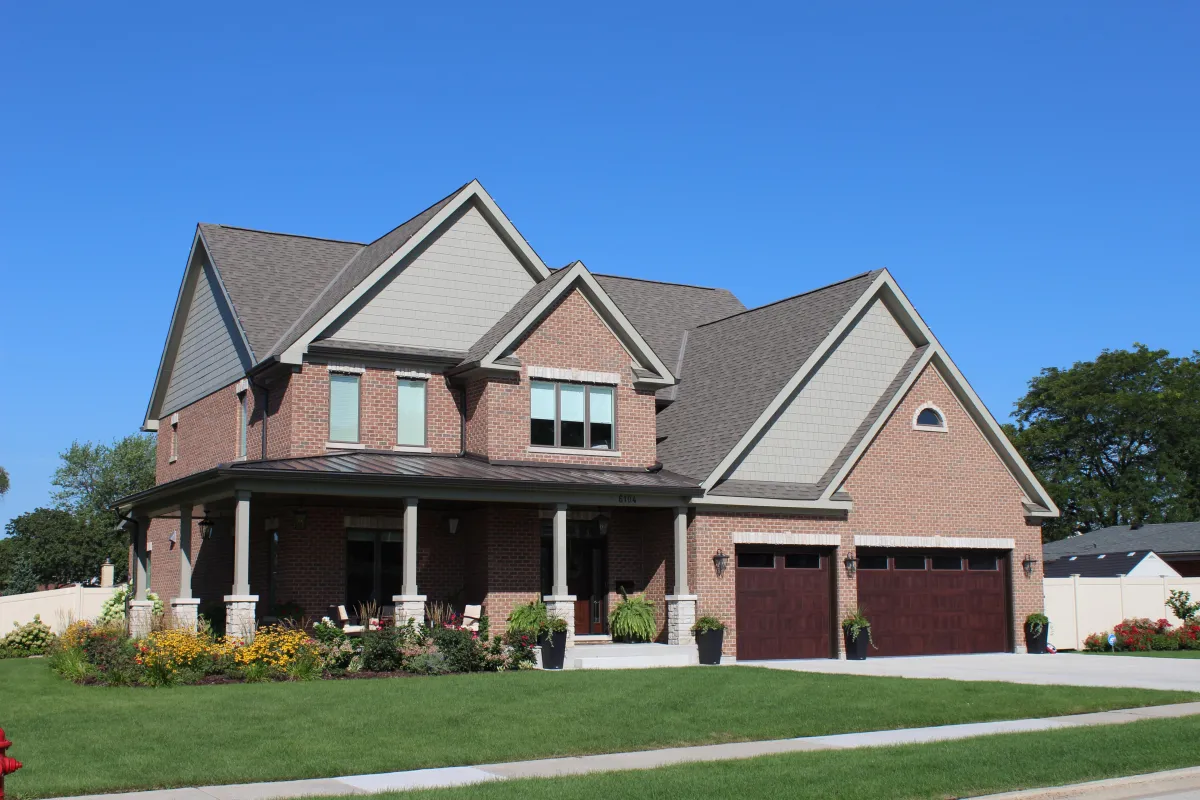 James Hardie siding project in Rosemont, IL featuring Monterey Taupe lap siding and James Hardie Straight Edge Shake for a timeless and durable home exterior.