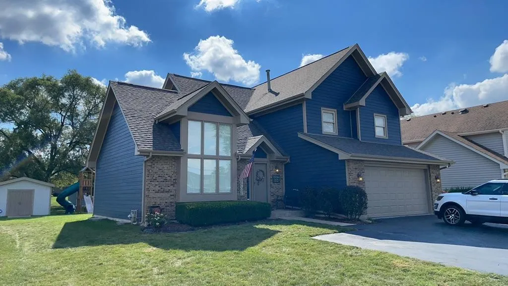 Northwind Exteriors James Hardie siding project in Itasca, IL featuring Deep Ocean siding with Khaki Brown trim, delivering a striking and durable home exterior upgrade.