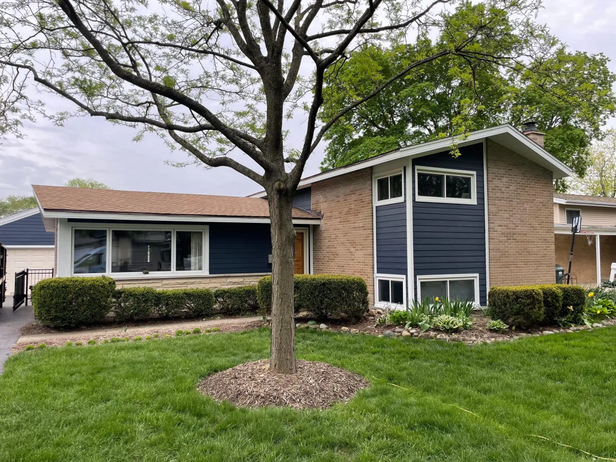 James Hardie siding project in Palatine, IL by Northwind Exteriors featuring Deep Ocean siding with Arctic White trim for a bold and striking home exterior.