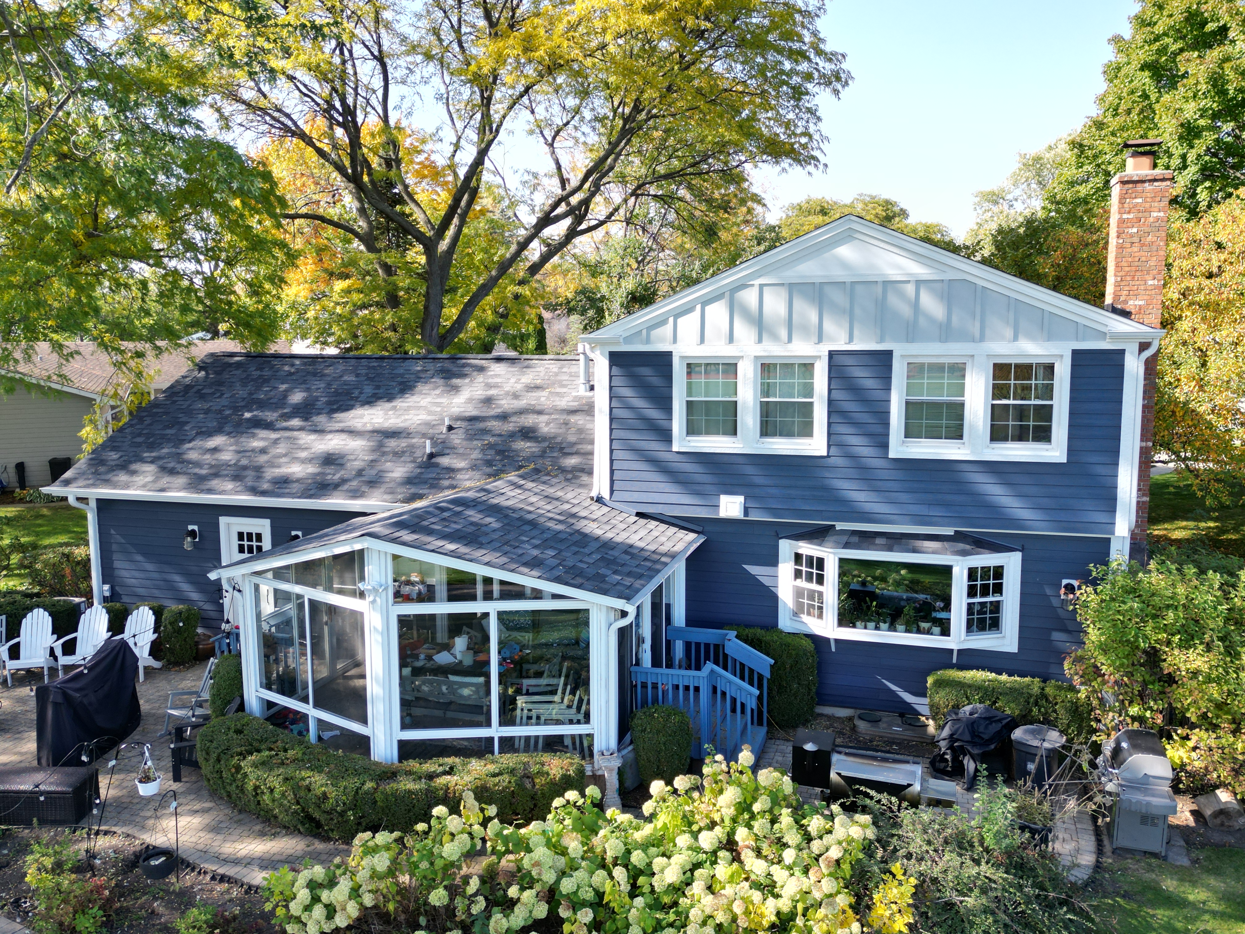 James Hardie siding installation in Buffalo Grove, IL featuring Deep Ocean siding, Arctic White trim, and Light Mist board and batten accents for a stunning and durable home exterior