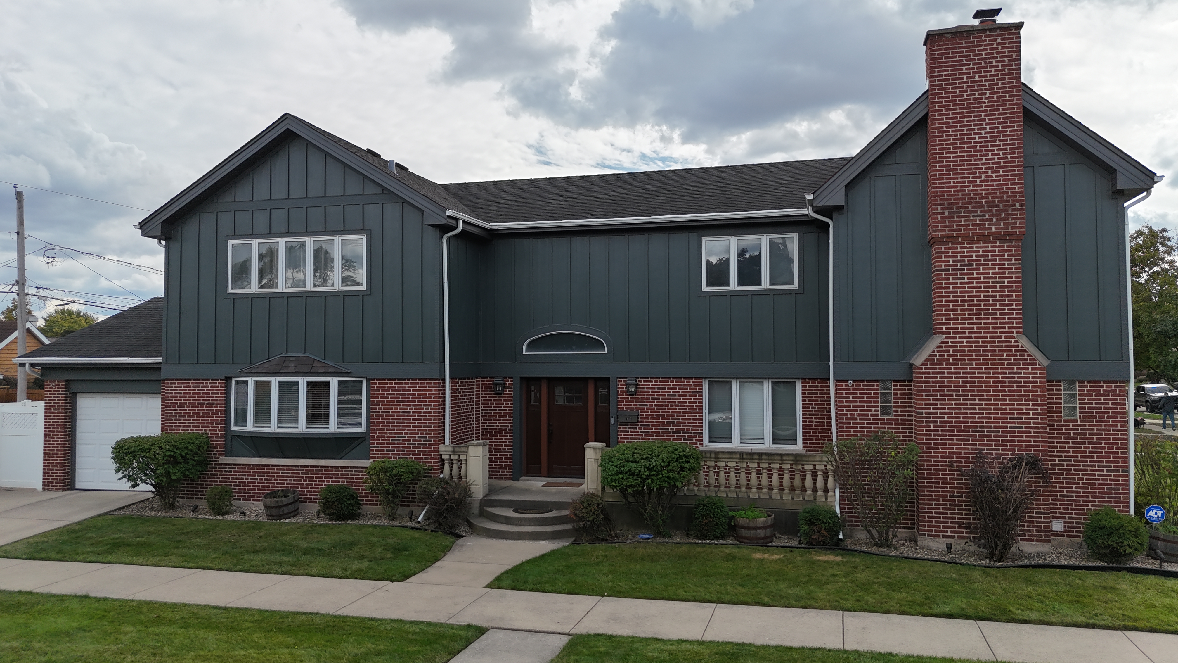 James Hardie siding project in Elmwood Park, IL featuring Evening Blue board and batten siding for a modern and durable home exterior.