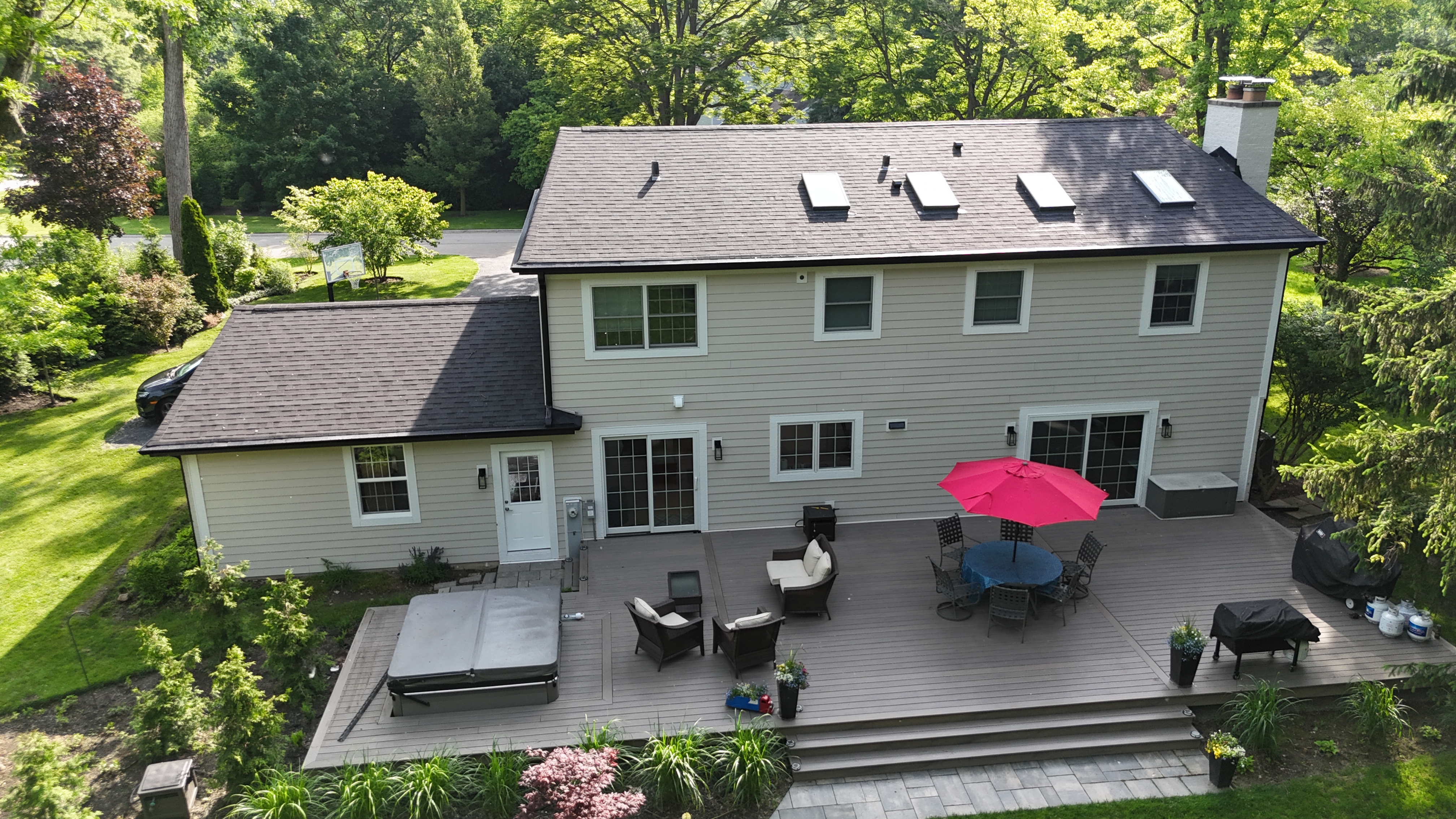 Malarkey Brilliant Black shingle roof installed by Northwind Exteriors in Lake Forest, IL, paired with black gutters and James Hardie Cobblestone siding for a cohesive and sophisticated exterior.