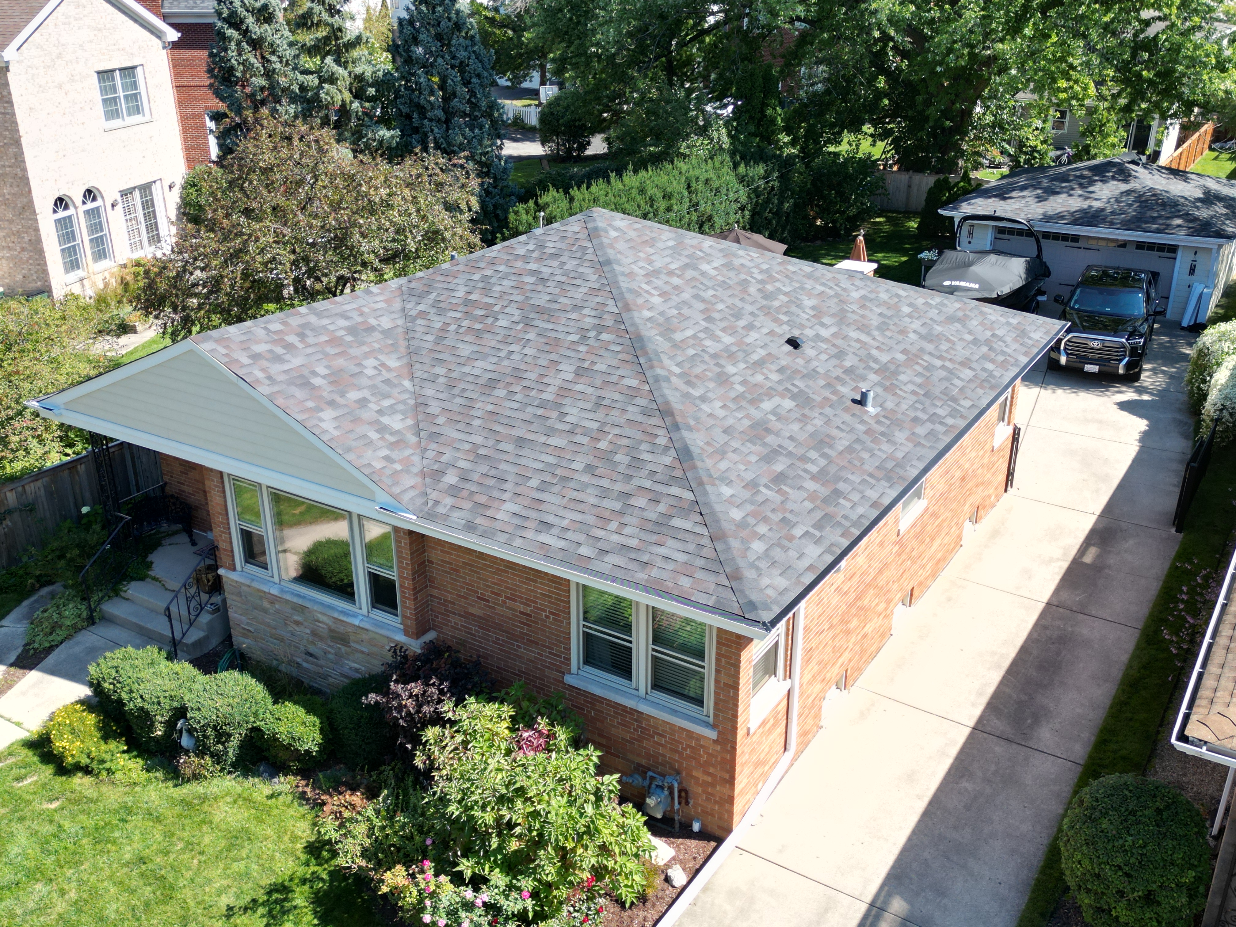 Malarkey Black Oak shingle roof installed by Northwind Exteriors on a home in Park Ridge, IL, perfectly complementing the Navajo Beige siding for a balanced and refined exterior.