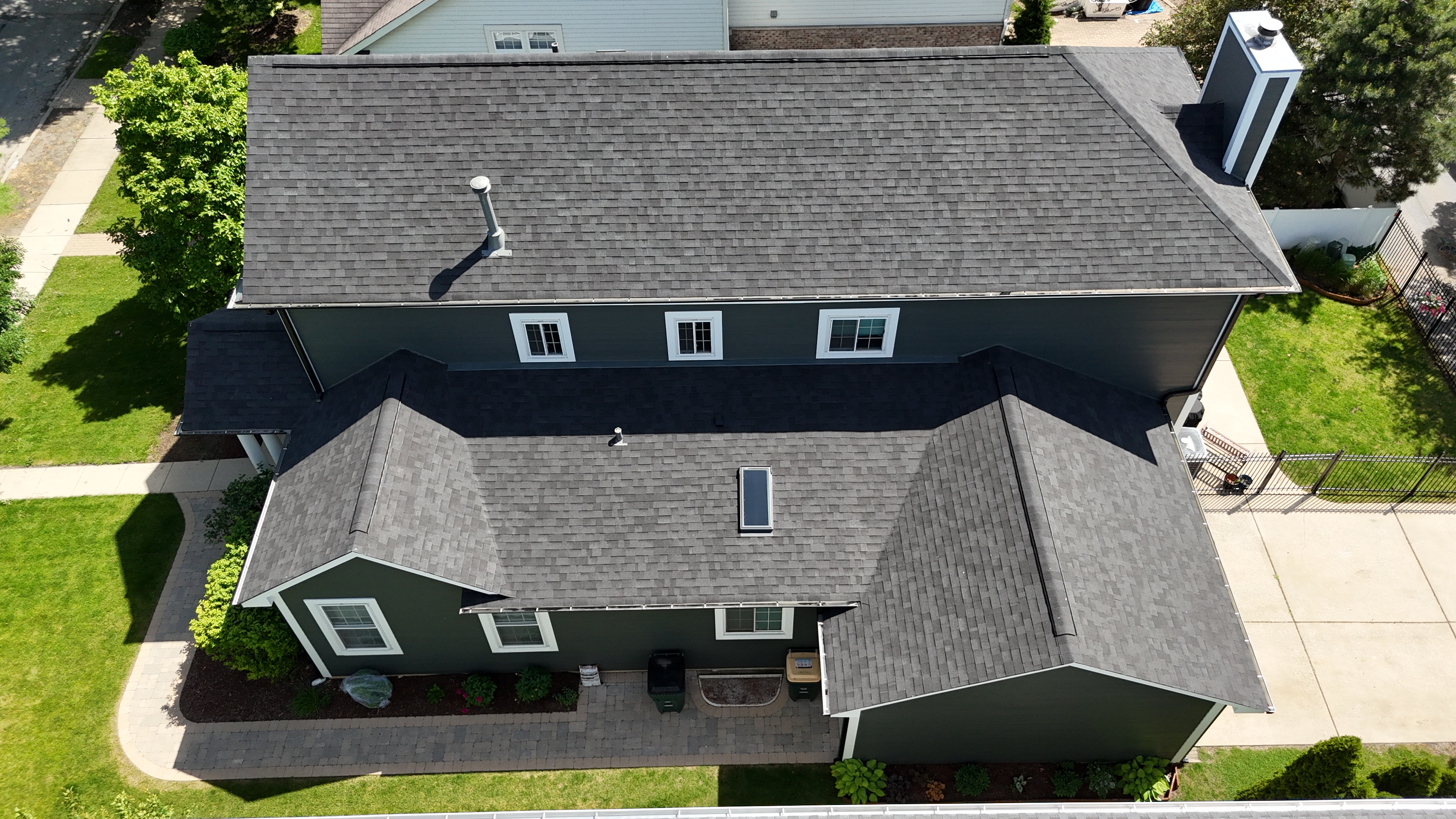 Malarkey Brilliant Black shingle roof installed by Northwind Exteriors in Park Ridge, IL, featuring new Velux skylights for enhanced natural light and modern appeal.