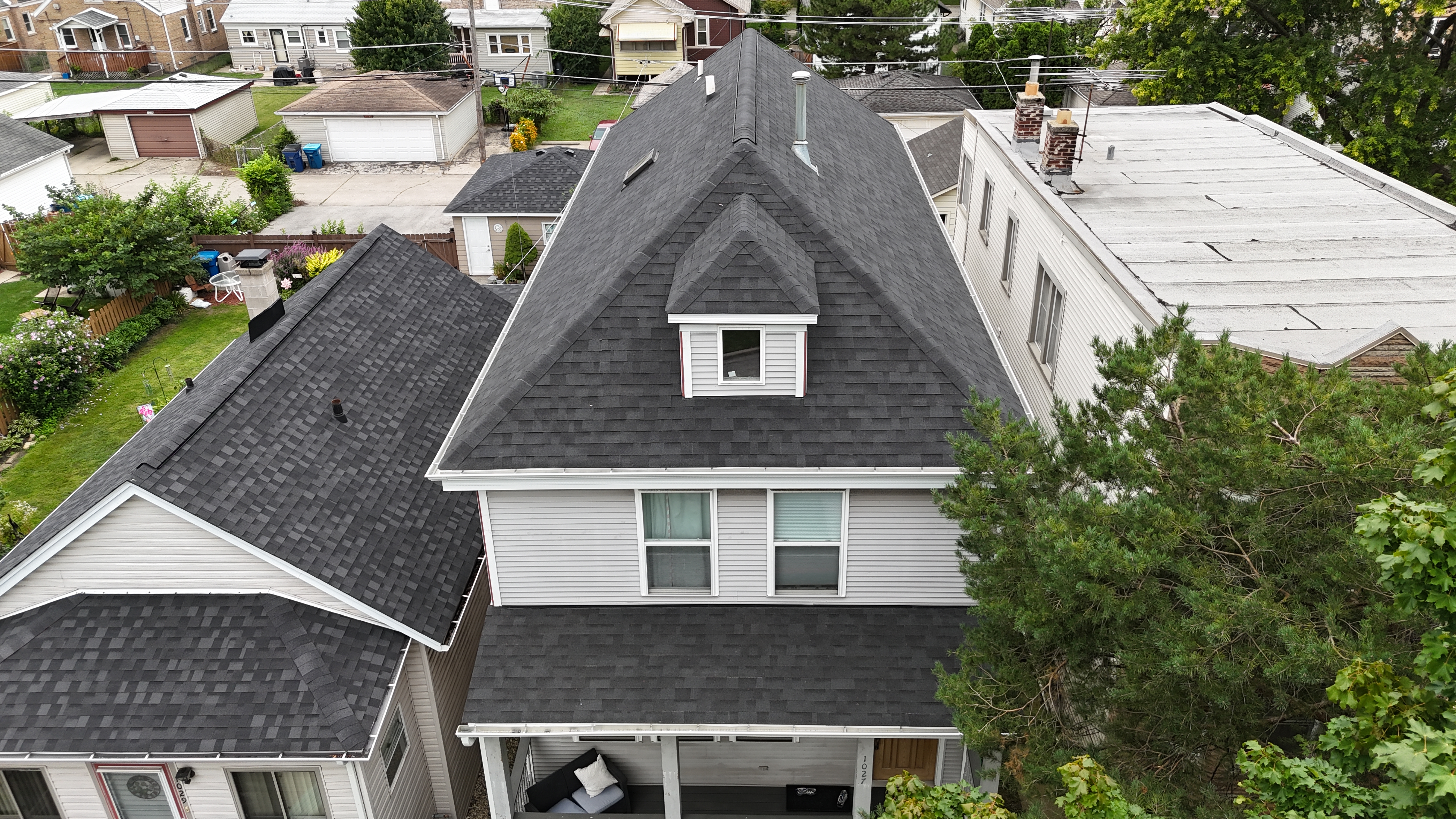 Malarkey Brilliant Black shingle roof expertly installed by Northwind Exteriors on a steep roof in Oak Park, IL, overcoming tight spacing and challenging conditions.