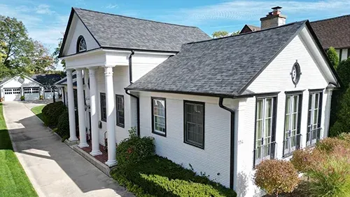 Malarkey Midnight Black roof with black gutters installed on a historic Park Ridge, IL home by Northwind Exteriors, creating a modern farmhouse look.