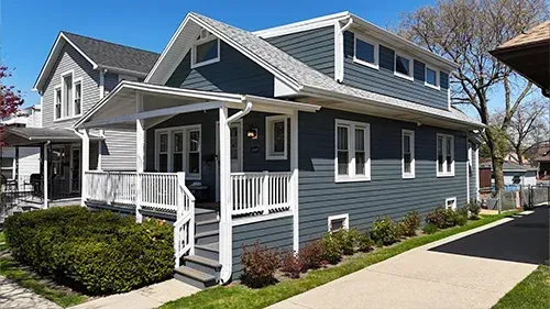 Evening Blue James Hardie siding with Arctic White trim installed on a home in the Edison Park neighborhood of Chicago by Northwind Exteriors