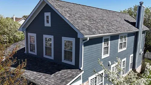 Evening Blue James Hardie siding with Arctic White trim and a Malarkey Storm Gray roof installed on a home in Park Ridge, IL by Northwind Exteriors.