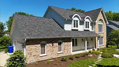 Arctic White James Hardie siding and Malarkey Black Oak roof with copper accents installed on a Wheaton, IL home by Northwind Exteriors