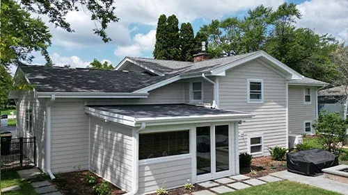 Cobblestone James Hardie siding with Arctic White trim installed on a Lake Forest, IL home by Northwind Exteriors, showcasing classic elegance