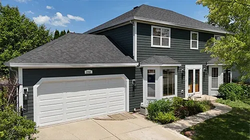 Iron Gray James Hardie siding with Arctic White trim and a Malarkey Brilliant Black roof installed on a home in Wilmette, IL by Northwind Exteriors.