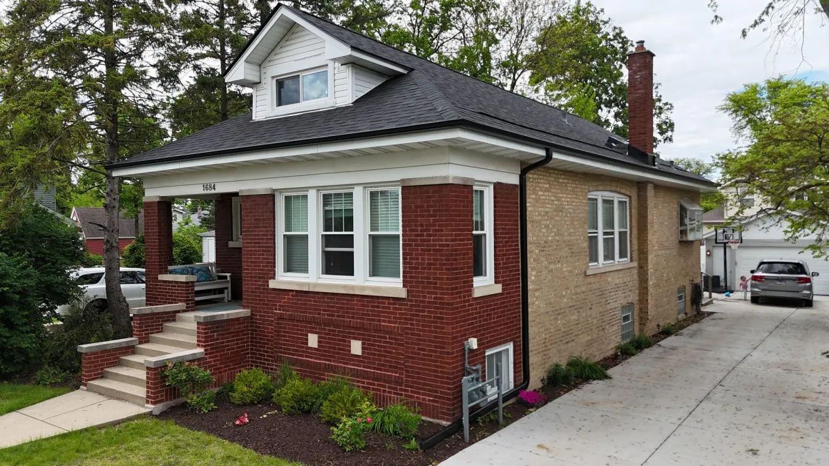 Arctic White James Hardie siding and Malarkey Black Oak roof with copper accents installed on a Wheaton, IL home by Northwind Exteriors