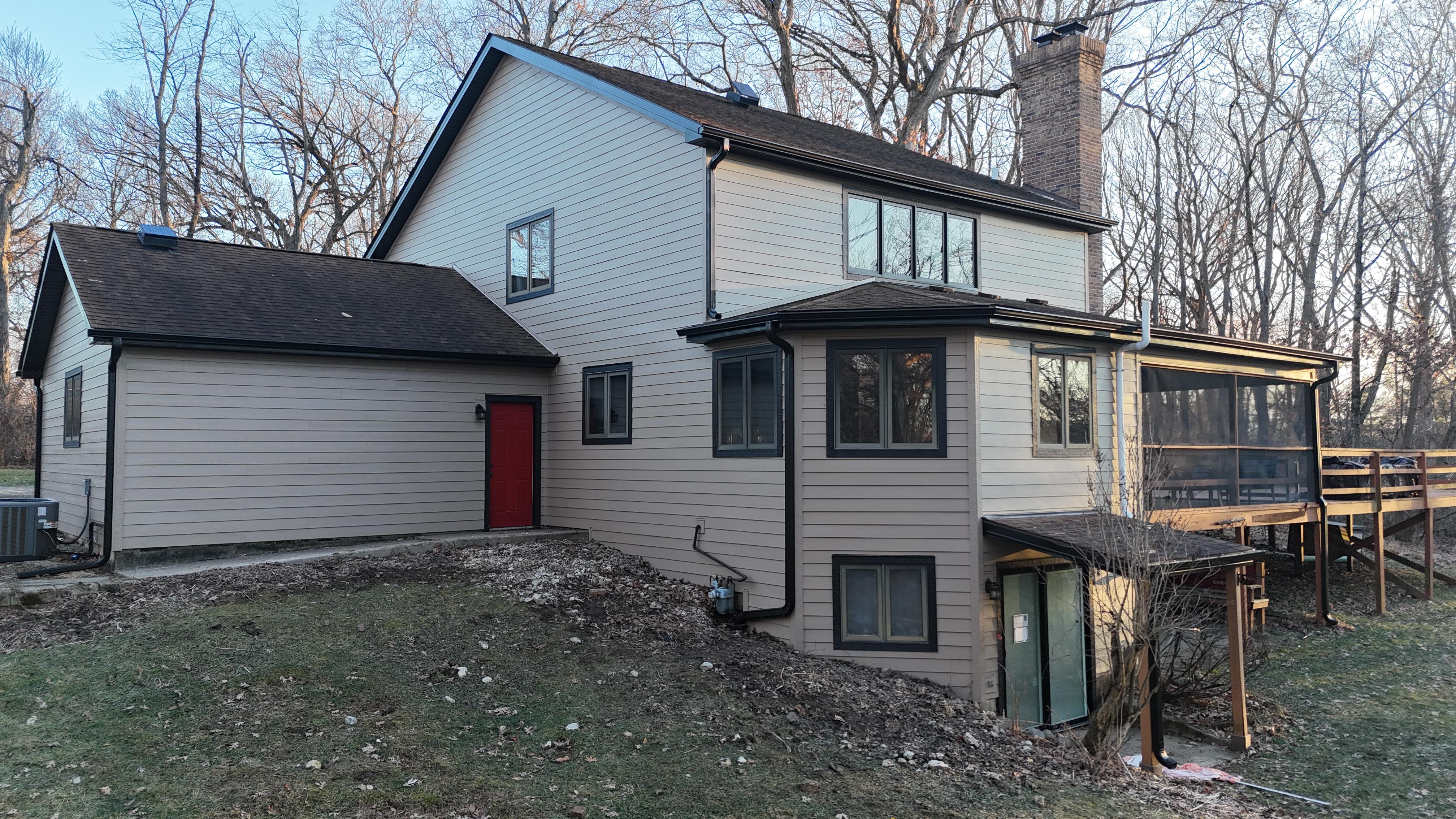 James Hardie Khaki Brown lap siding with Midnight Black trim and soffits on a custom home in Long Grove, IL by Northwind Exteriors.