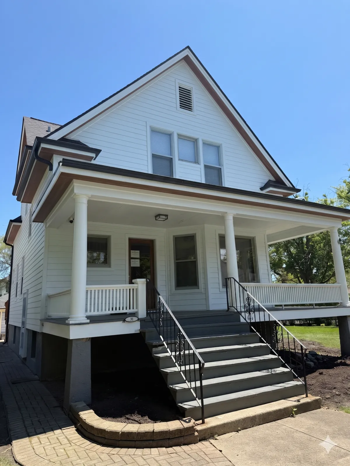 A home exterior renovation in La Grange, IL, by Northwind Exteriors featuring Arctic White James Hardie siding & Woodtone soffit.