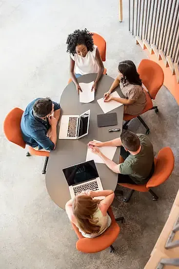 A marketing team sitting around a table coming up with a growth strategy for a local business