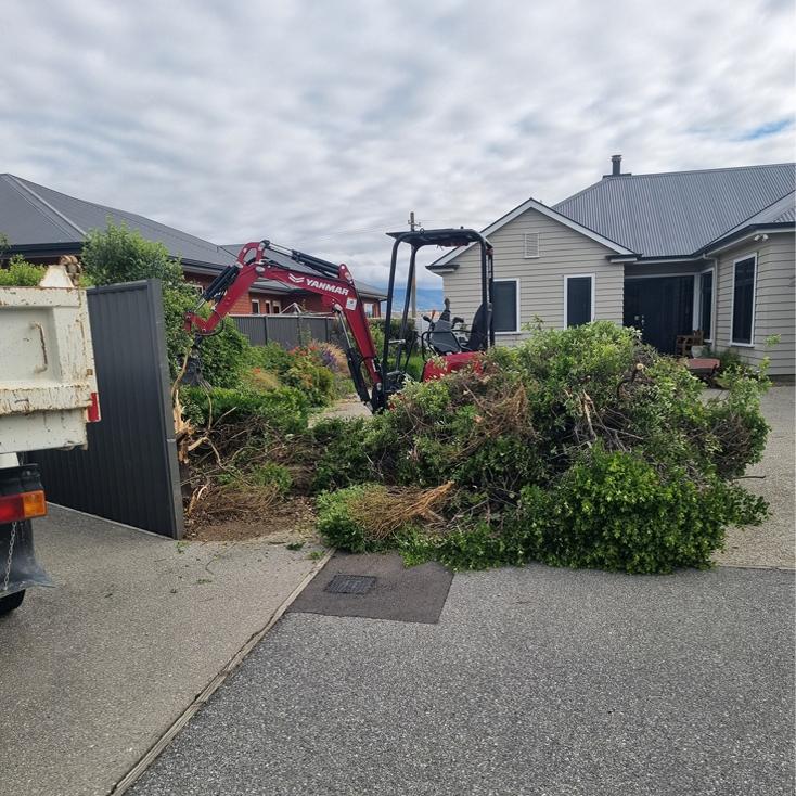 Shrubs being cleared with small excavator near a Central Otago home