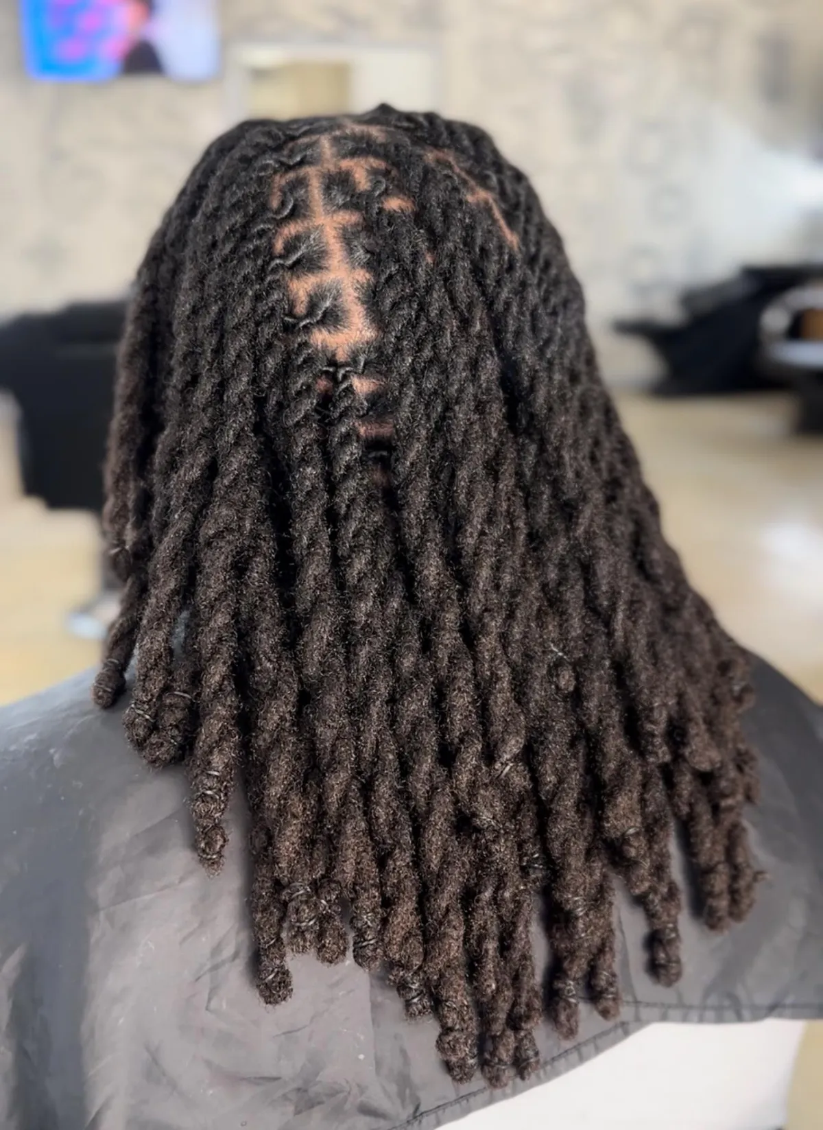 Stunning long loc extensions demonstrating undetectable integration and mature appearance.