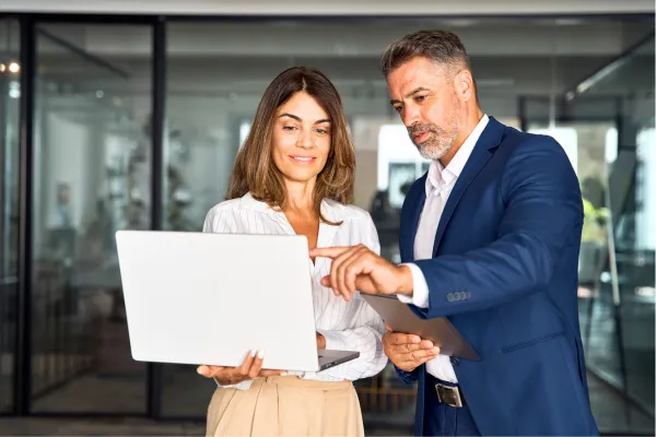 professional business man and woman looking at a laptop