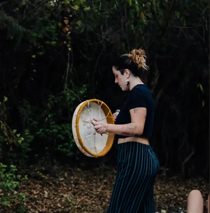 Luis M., a middle-aged Latino man, clean-shaven, wearing a navy suit and open-collar shirt, standing confidently with arms crossed, soft blue background. His expression is focused and inspiring, suggesting expertise and leadership.