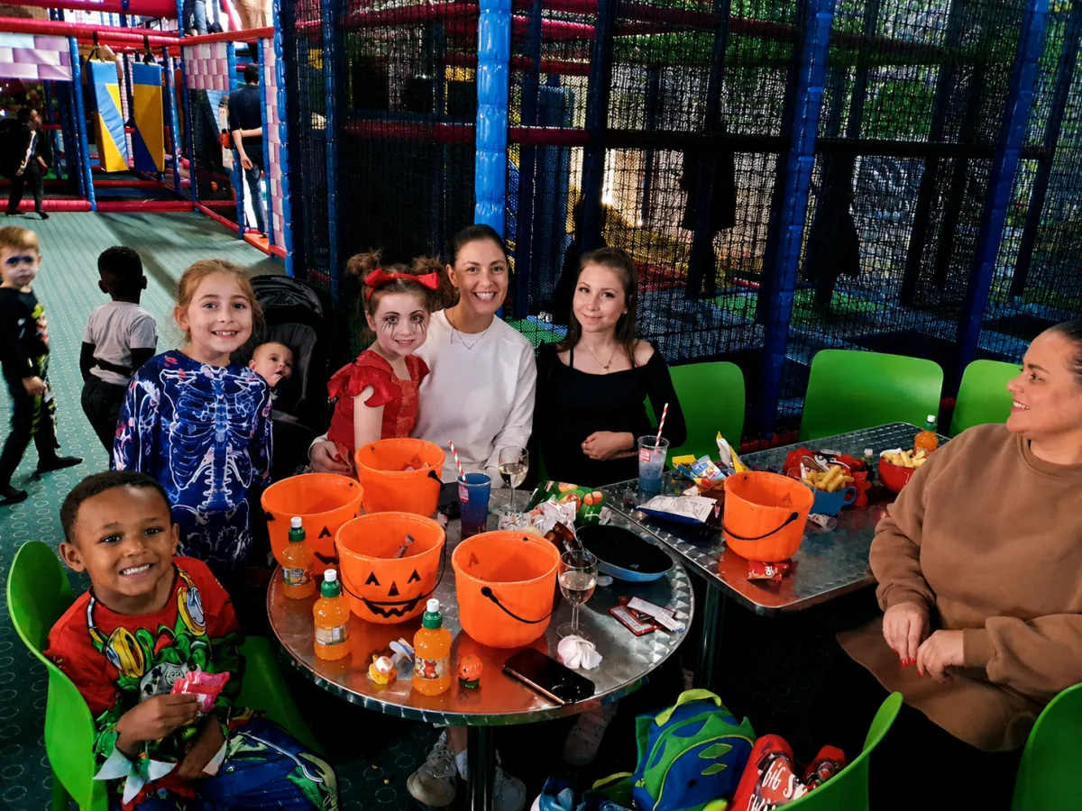 Friendly toddlers enjoying soft play in colorful Halloween costumes