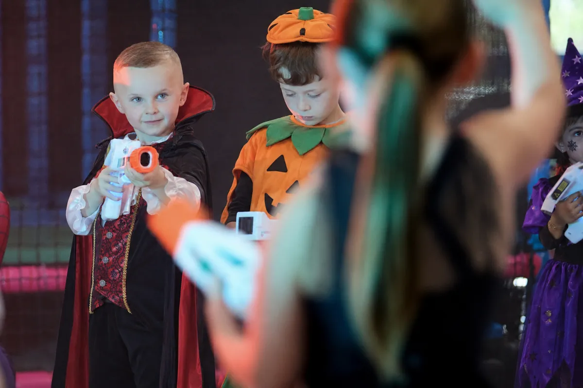 Kids playing laser tag in a neon arena
