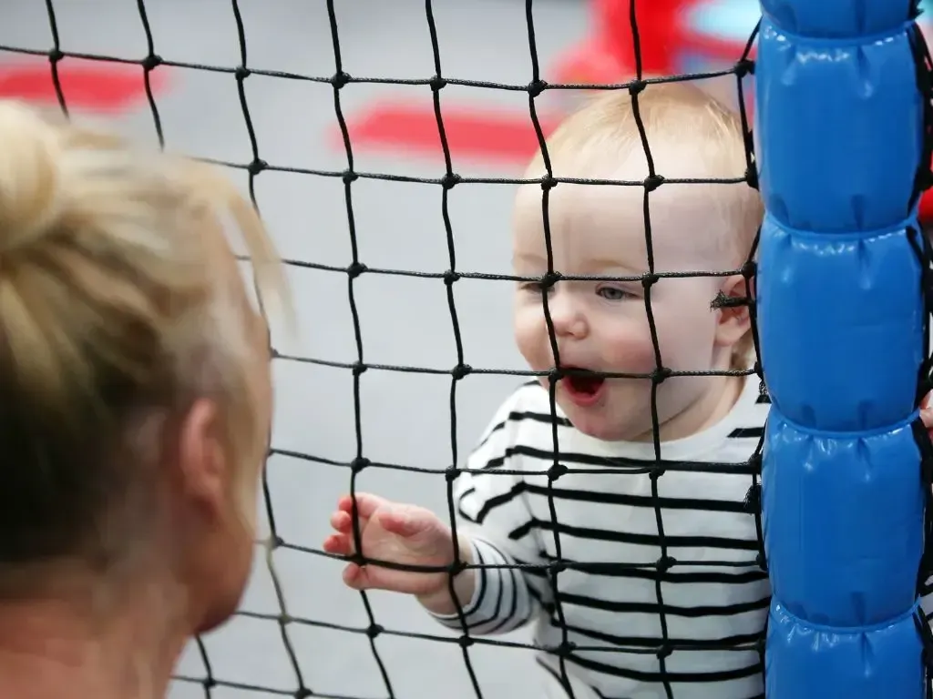 Toddler enjoying the padded indoor play area
