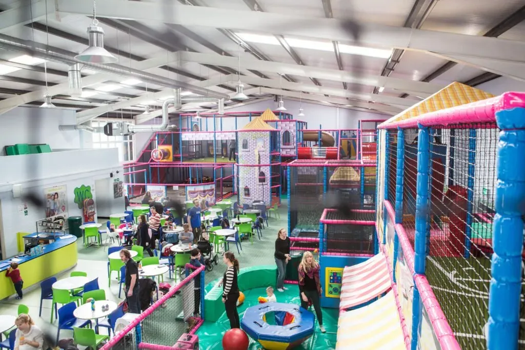 Comfortable family seating area near the toddler play zone at Party and Play Funhouse