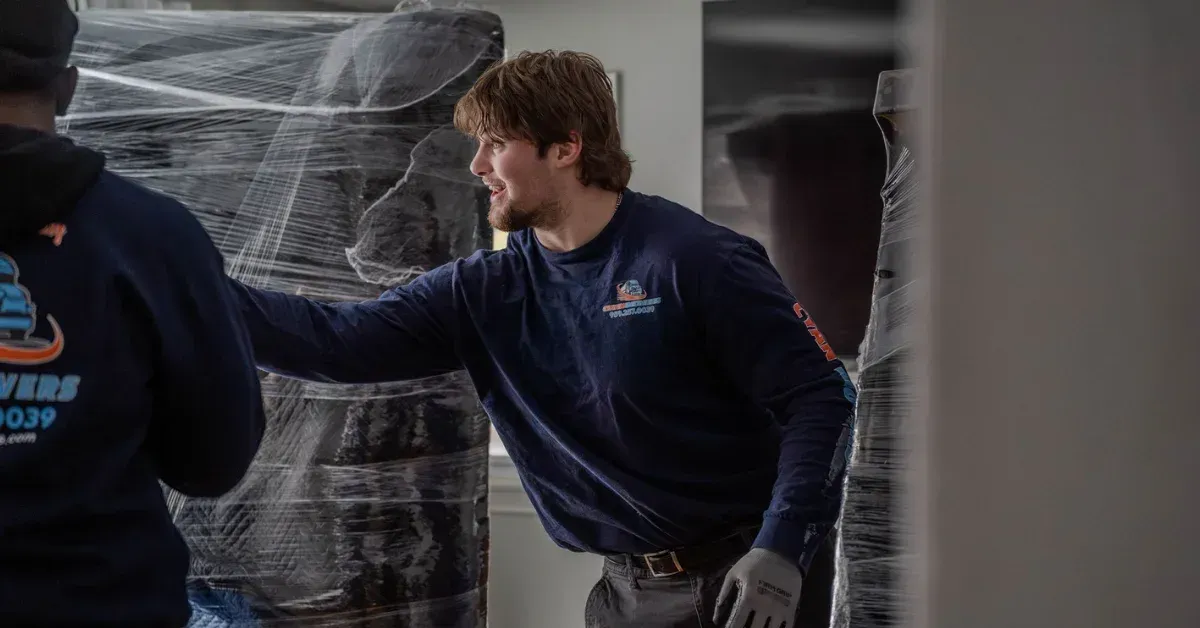 Cyan Movers professional movers wrapping and protecting furniture during a residential move in Manchester CT