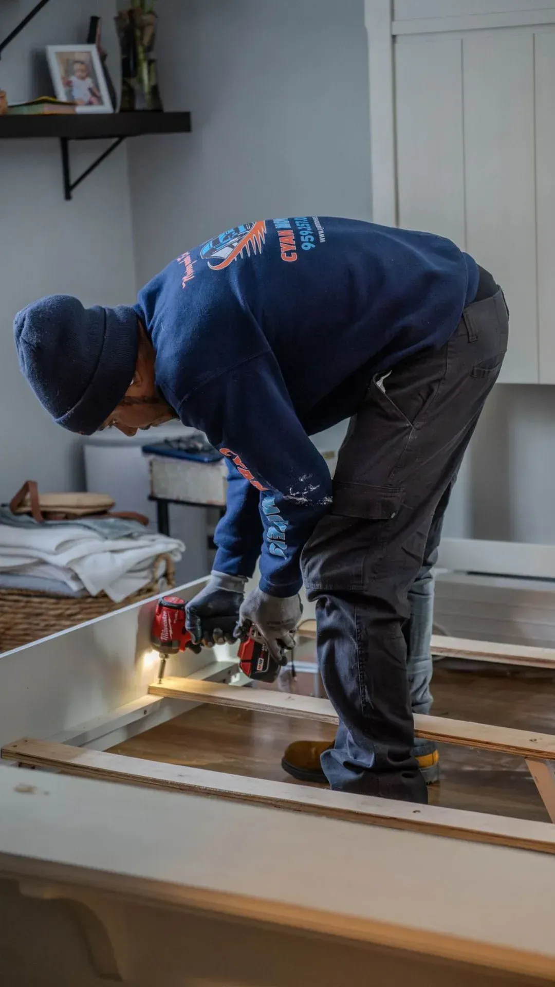 Professional mover disassembling furniture during a residential move in Connecticut