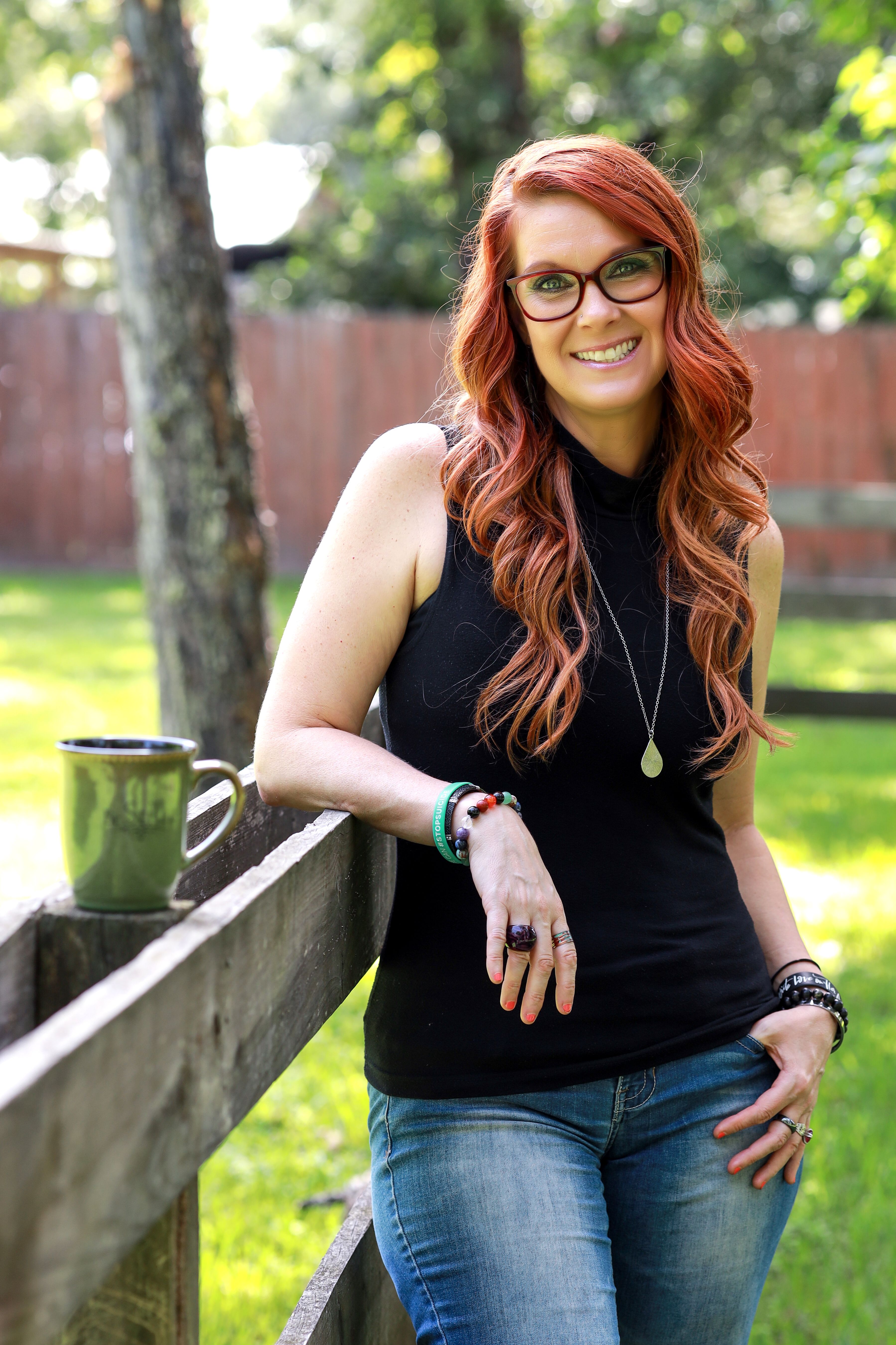 a small buddha statue sitting on top of a moss covered rock