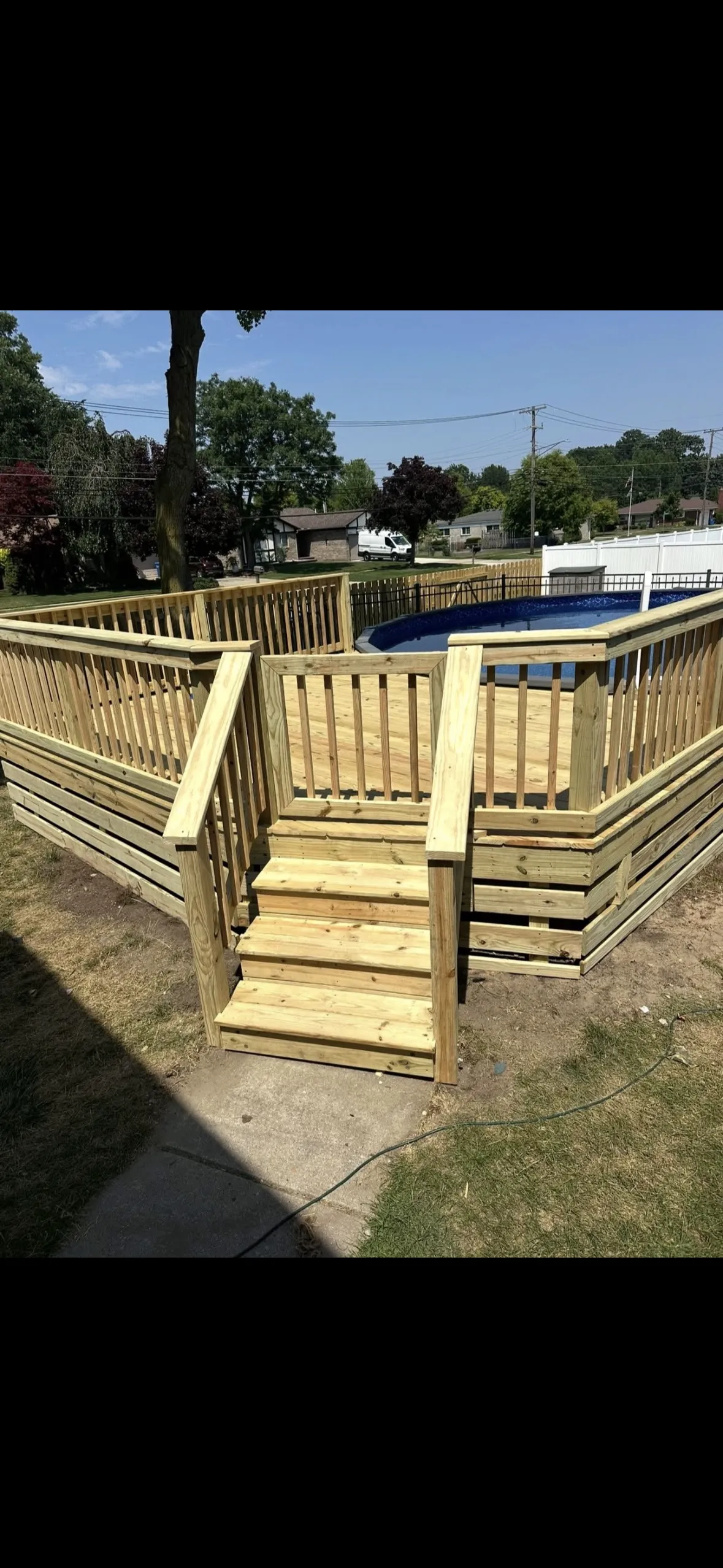 Pressure-treated pool deck with stairs and railing built by TBL Construction, Downriver Michigan