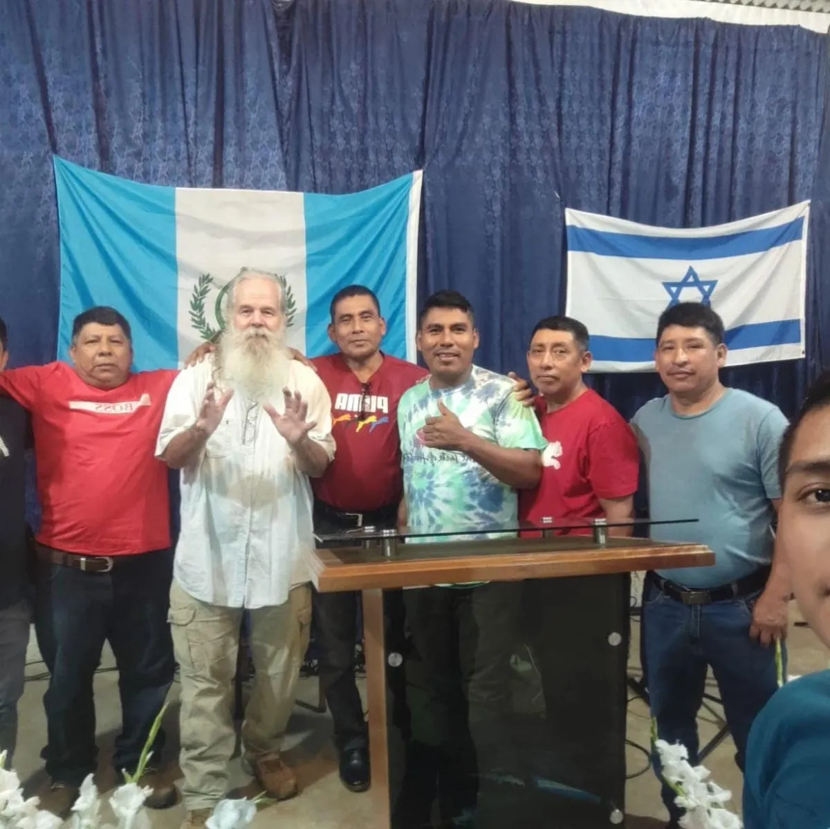 green and white lighthouse near body of water under cloudy sky during daytime