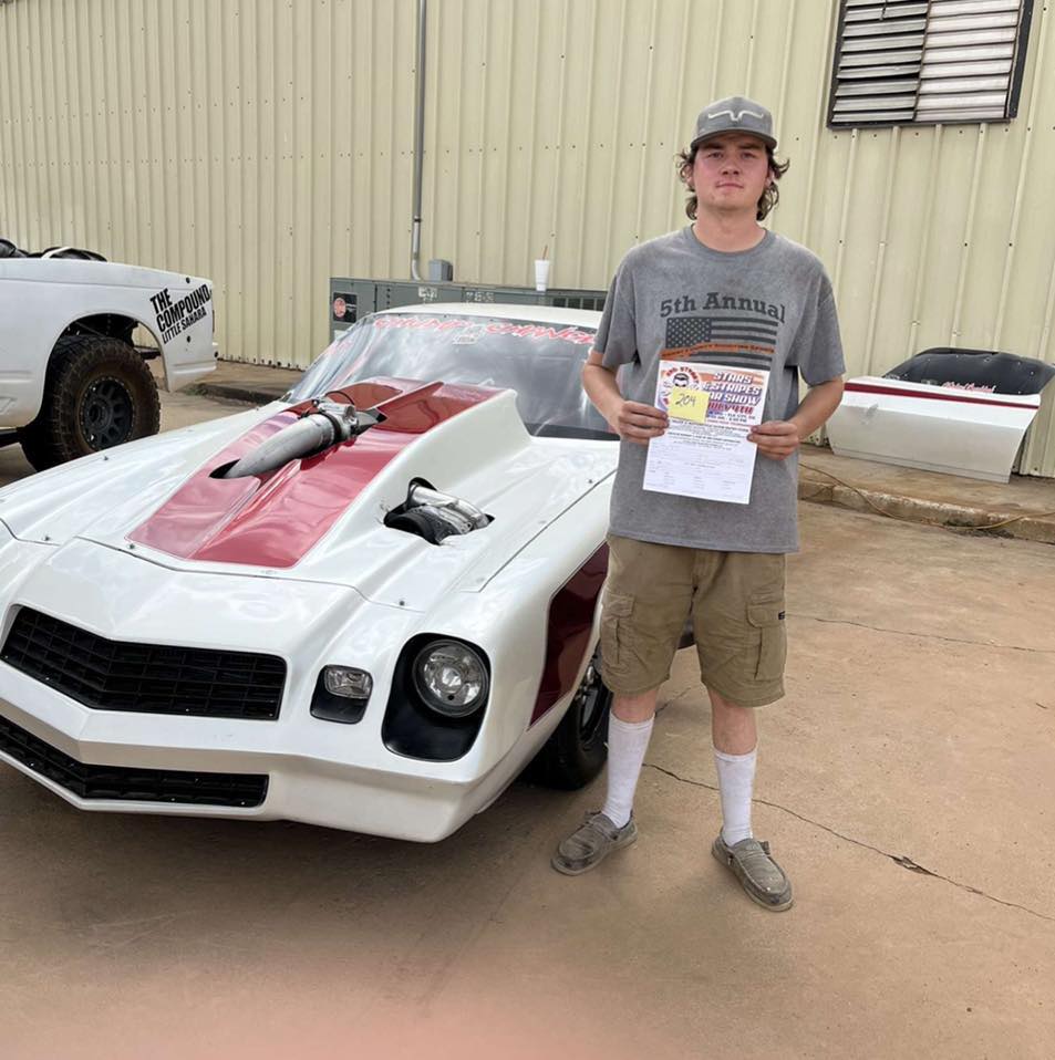 A dirt road in the middle of a green field