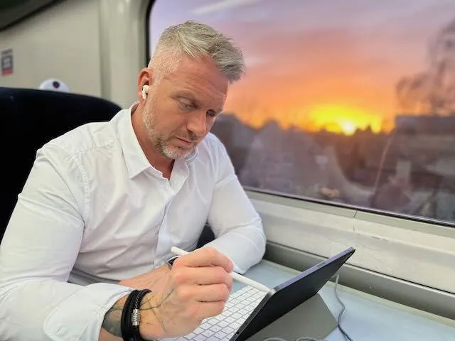 Bertie using an ipad infront of a sunset
