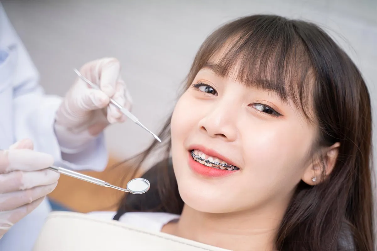 Patient receiving a braces adjustment check-up at Kong Dental Surgery in Singapore.
